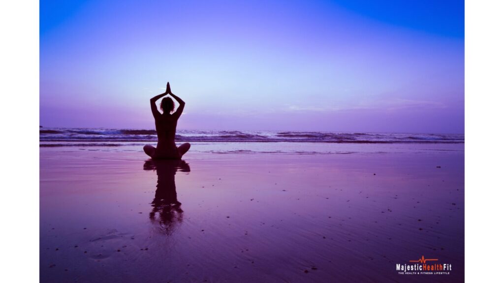 Woman practicing yoga on the beach at night for relaxation and mindfulness"