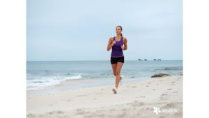 Woman running on the beach for fitness and well-being"