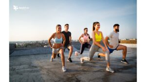 Group of people working out outdoors, showcasing the benefits of fitness in a natural environment."