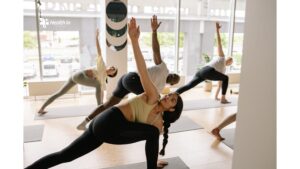 A yoga class with participants practicing various poses, emphasizing the collective benefits of a structured yoga session