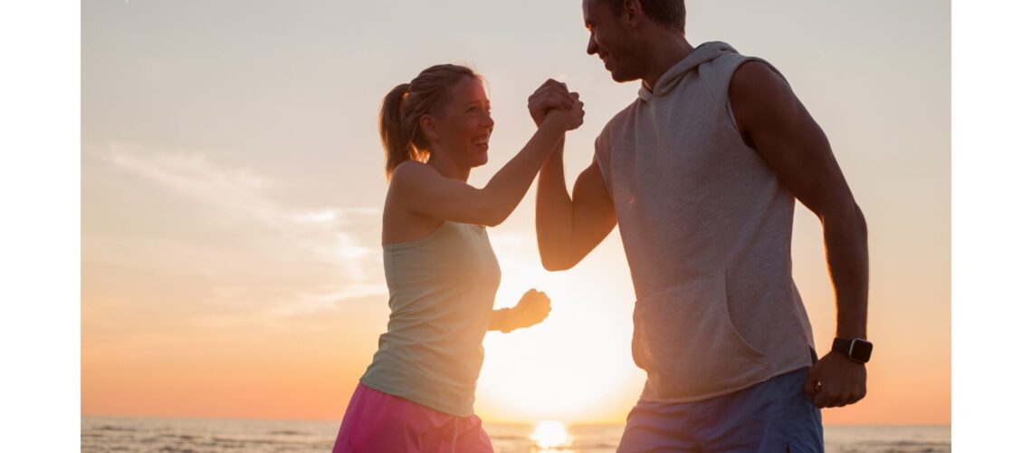 A man and woman walking on the beach, symbolizing a balanced lifestyle and the pursuit of wellness in 2024."