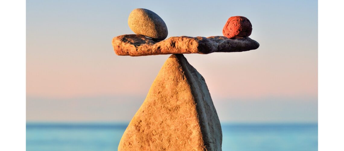 Well-balanced rocks on a beach, symbolizing harmony and the importance of wellness & health in life