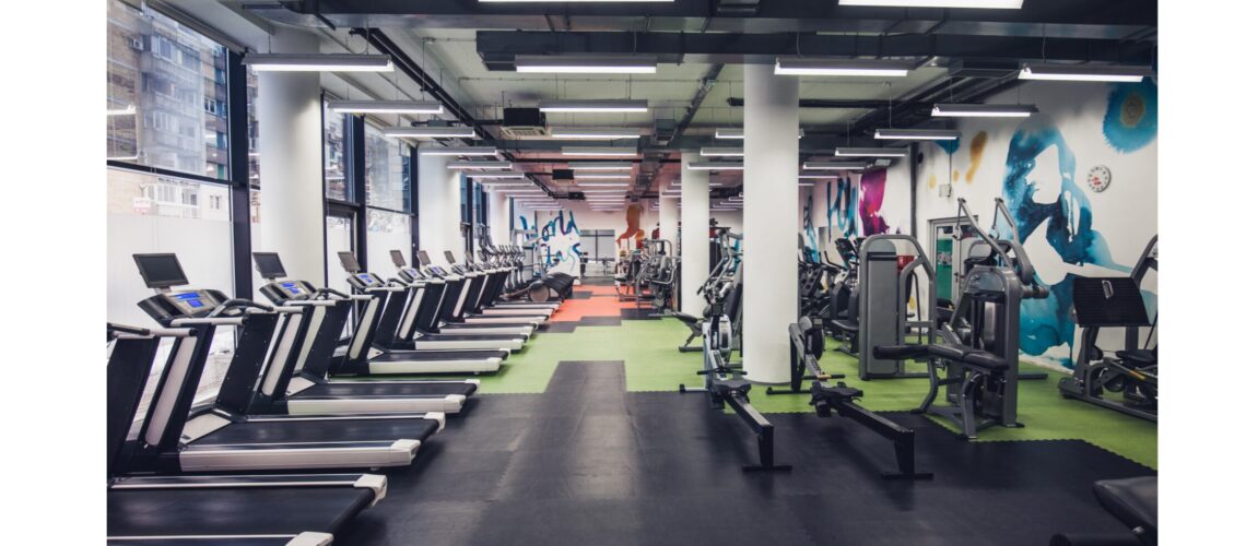 Interior of a fitness gym filled with modern equipment, highlighting the variety of tools available for effective workouts."