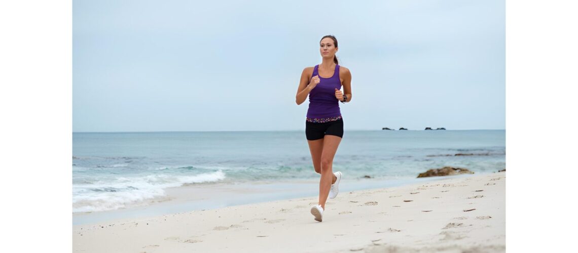 Woman running on the beach for fitness and well-being"