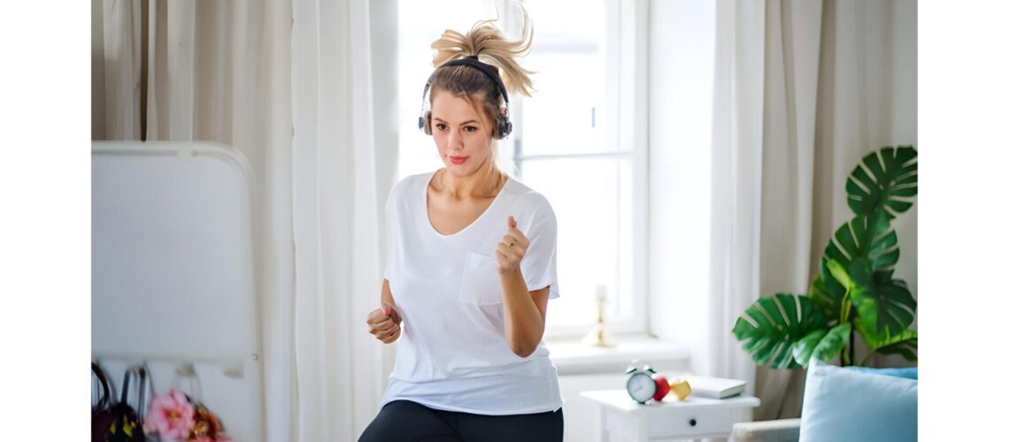 Woman doing cardio exercises at home for full-body strength and heart health.