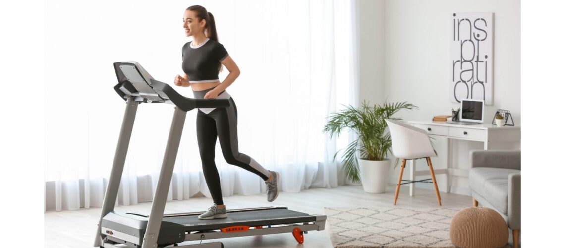 Woman running on a treadmill at home, staying motivated in her fitness journey."